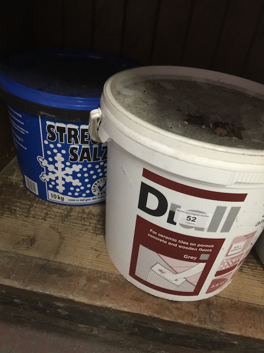 A 14.6 kg tub of Diall ceramic floor tile adhesive and grout and a 10 kg tub of de-icing salt.