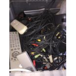 A box of cables and remotes