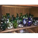 A shelf of Mary Gregory style green and blue vases, jugs etc.