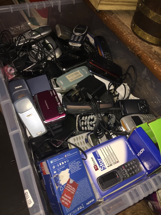 A large box of vintage Nokia and Samsung mobile phones + chargers