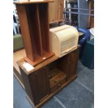 A pine av cabinet with cd cupboards and another small storage cabinet