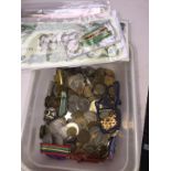 A box of world bank notes, coins and medals