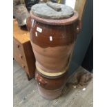 Two large stoneware pottery urns with wooden lids