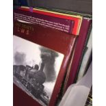 A box of steam train books and DVDs