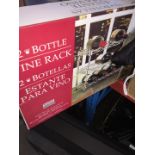 A boxed 12 bottle metal wine rack