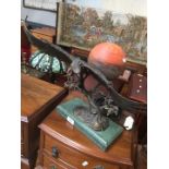 A gilt metal ornamental eagle table lamp on granite base with spherical glass marble effect shade.