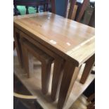 A modern light oak nest of tables