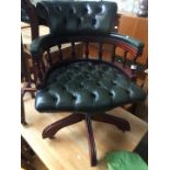 A reproduction green buttoned leather captains swivel chair