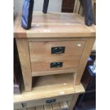 A modern light oak bedside chest