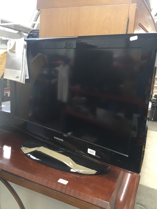 A Samsung 32" LCD TV with manual and remote