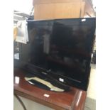 A Samsung 32" LCD TV with manual and remote