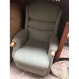 A green fabric manual reclining armchair
