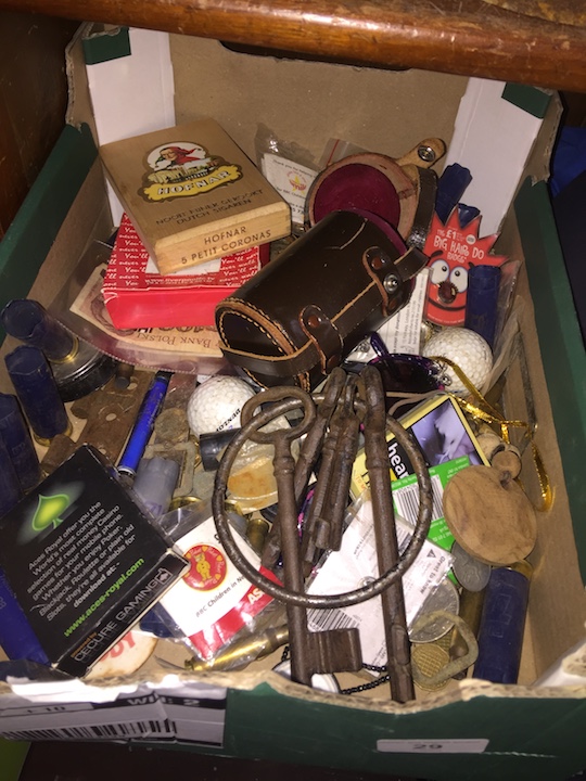 A box of collectables including big jail keys, coins, etc.