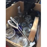 A box containing assorted glass jars and small round mirror