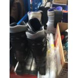 Pair of ski boots, pair of roller blades and a pair of grab handles.