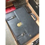 A box containing Pierre Cardin briefcase and other purses