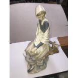 Lladro figure of a woman seated on a branch