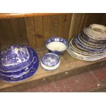 A shelf of blue and white and other pottery