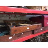 Three wooden trays containing a variety of tools