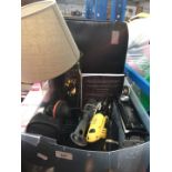 A box of mixed items including JVC car radio, multi tool, camera, etc