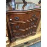 A reproduction Georgian style burr walnut serpentine chest of 3 drawers
