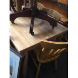 A lightwood dining table and 6 country kitchen style chairs