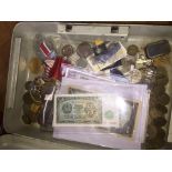 A tin of world bank notes, coins and medals