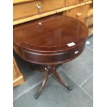 A reproduction mahogany drum table