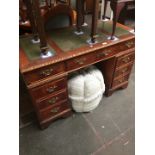 A mahogany reproduction pedestal desk with tooled leather top