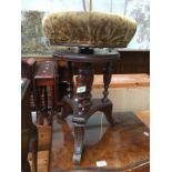 A Victorian revolving piano stool