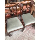 A pair of 19th century rosewood chairs with carved backs