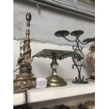 A brass tazza, brass lamp and a candelabra