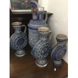 Four pieces of German salt glazed stoneware comprising a large ewer and three flasks.