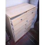 A light wood effect chest of drawers