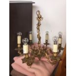 An ornate gilt metal chandelier light fitting