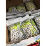 A box of sealed bags of Crivit golf tees. - Each pack containing 150 tees.