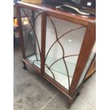 A 1940s glazed display cabinet on claw and ball feet