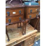 A pair of reproduction mahogany bedside cabinets with burr wood drawer fronts