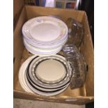 A box of dinner plates and glass bowls