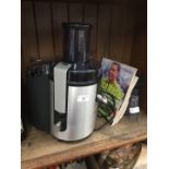 A Philips HR1861 whole fruit juicer complete with instructions manual and book related to juices and