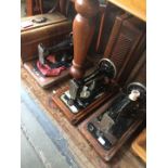 Three late 19th/early 20th century hand crank sewing machines comprising a Frister & Rossmann and