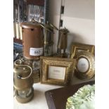 A collection of brass lanterns and photo frames