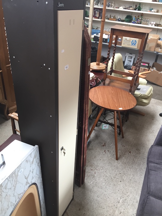 A tall narrow metal storage cupboard