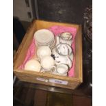 Miniature tea set in a wooden tray