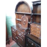 An oak dresser with domed top.