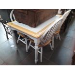 A tile topped kitchen table and 4 matching chairs with cushions