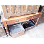 A Victorian two drawer mahogany side table with turned H frame stretcher.