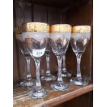 A set of six gilt wine glasses with twisted stems.