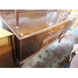 A mahogany sideboard on claw and ball feet with rail back