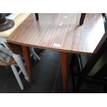 A vintage 1960s formica top drop leaf table